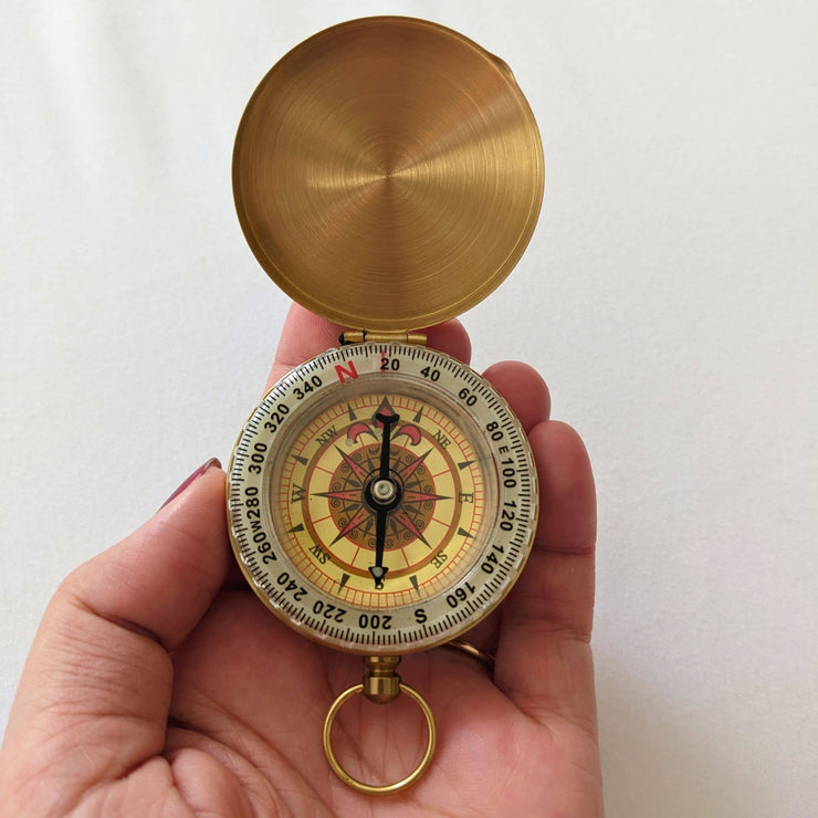 hand holding compass