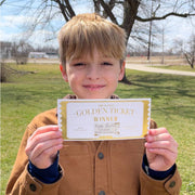 kid holding golden ticket scavenger hunt prize