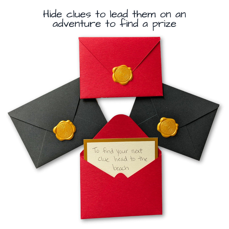 red and black scavenger hunt clues in wax sealed envelopes